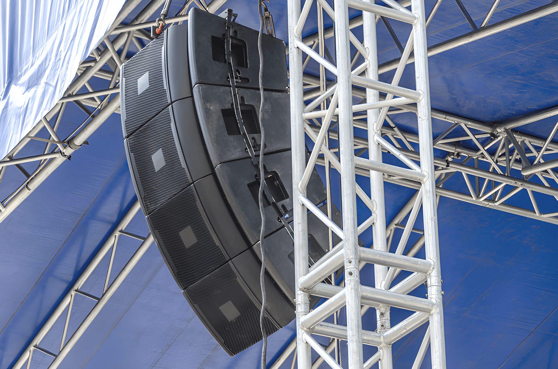 Line-array speakers rigged on truss over an outdoor stage — outdoor sound system rental Singapore